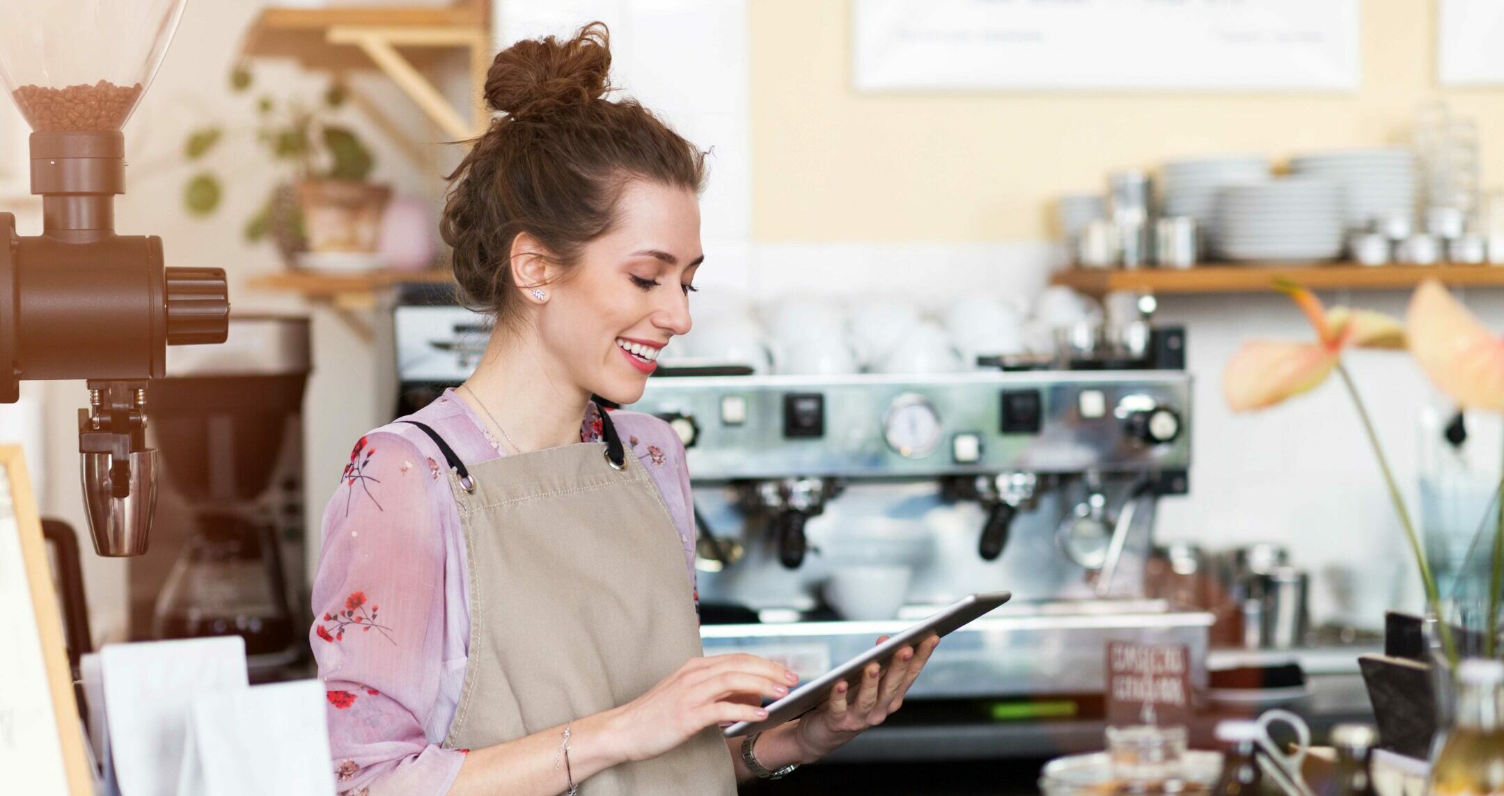 Young woman using digital tablet in coffee shop