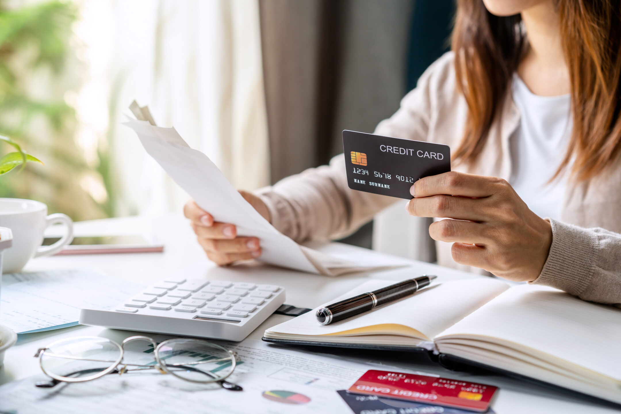 Stressed young woman calculating monthly home expenses, taxes, bank account balance and credit card bills payment, Income is not enough for expenses